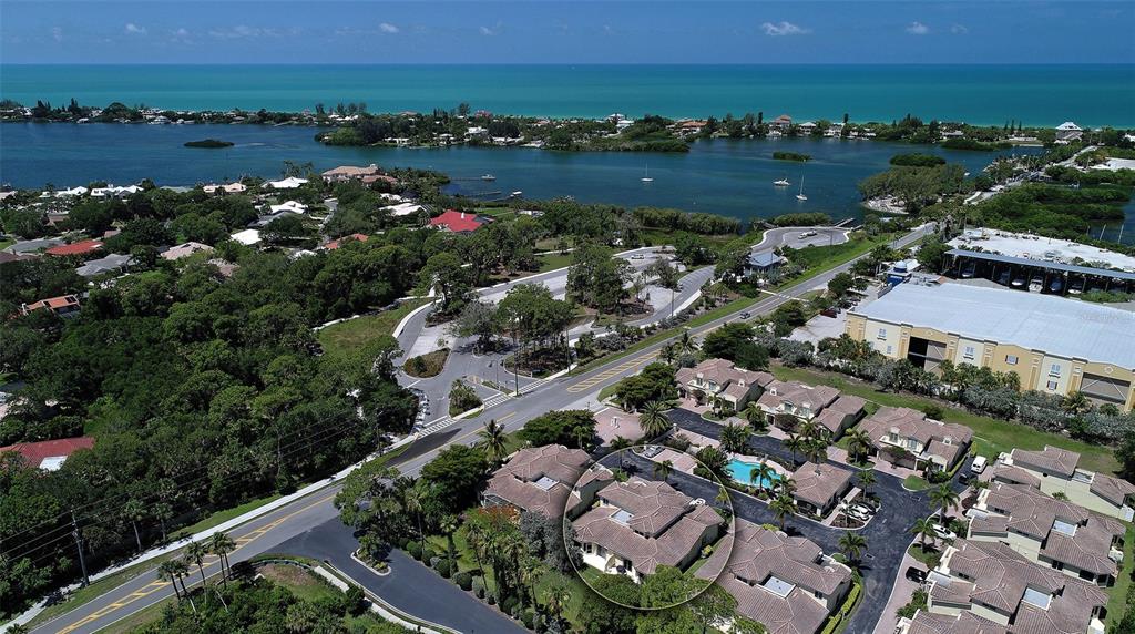 1116 Beachcomber Court, Unit 3 Osprey, FL 34229 - Photo 1 of 65 an aerial view of city and lake with trees all around