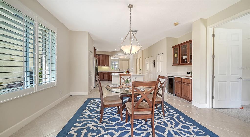 1116 Beachcomber Court, Unit 3 Osprey, FL 34229 - Photo 18 of 65 a view of a dining room with furniture window and wooden floor