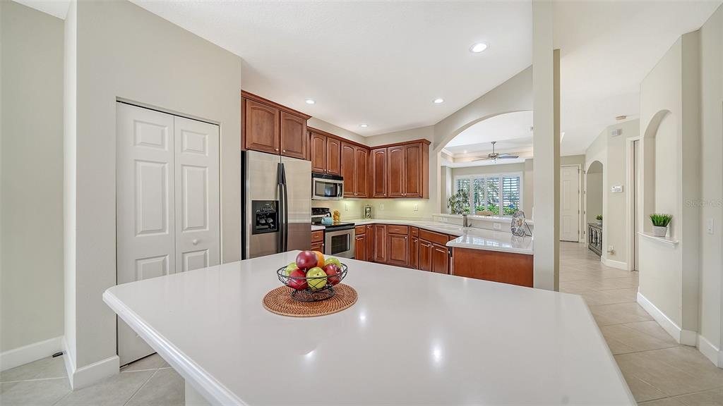 1116 Beachcomber Court, Unit 3 Osprey, FL 34229 - Photo 20 of 65 a kitchen with stainless steel appliances a dining table and wooden floor