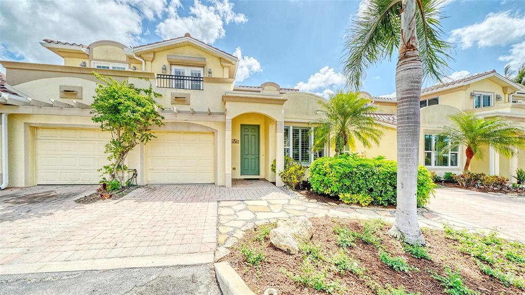 1116 Beachcomber Court, Unit 3 Osprey, FL 34229 - Photo 2 of 65 a front view of a house with a yard and garage