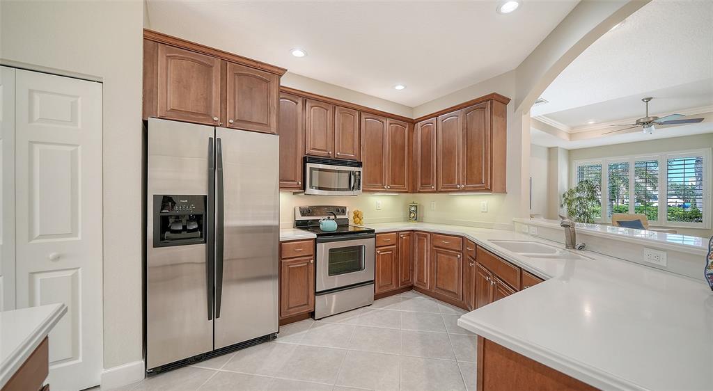 1116 Beachcomber Court, Unit 3 Osprey, FL 34229 - Photo 21 of 65 a kitchen with stainless steel appliances granite countertop a refrigerator and a sink