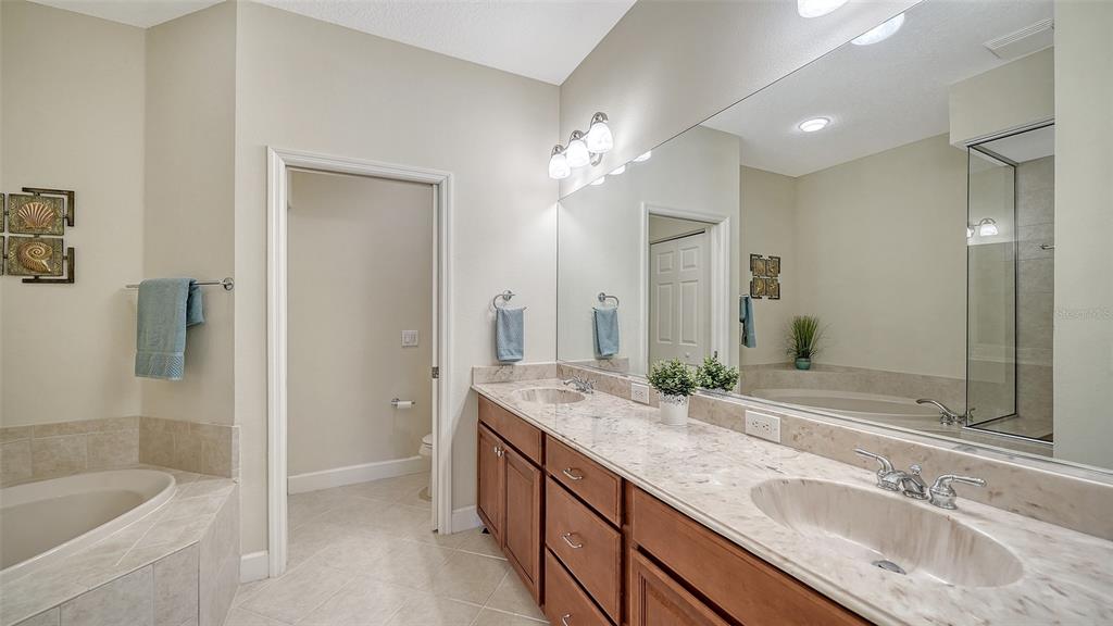 1116 Beachcomber Court, Unit 3 Osprey, FL 34229 - Photo 28 of 65 a bathroom with a granite countertop double vanity sink mirror and shower