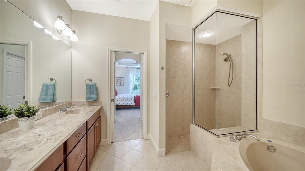 1116 Beachcomber Court, Unit 3 Osprey, FL 34229 - Photo 29 of 65 a spacious bathroom with a granite countertop sink a mirror and shower