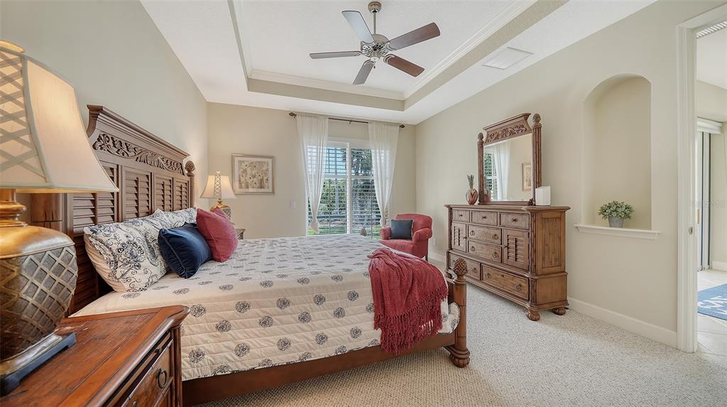 1116 Beachcomber Court, Unit 3 Osprey, FL 34229 - Photo 30 of 65 a bedroom with a bed and a chandelier