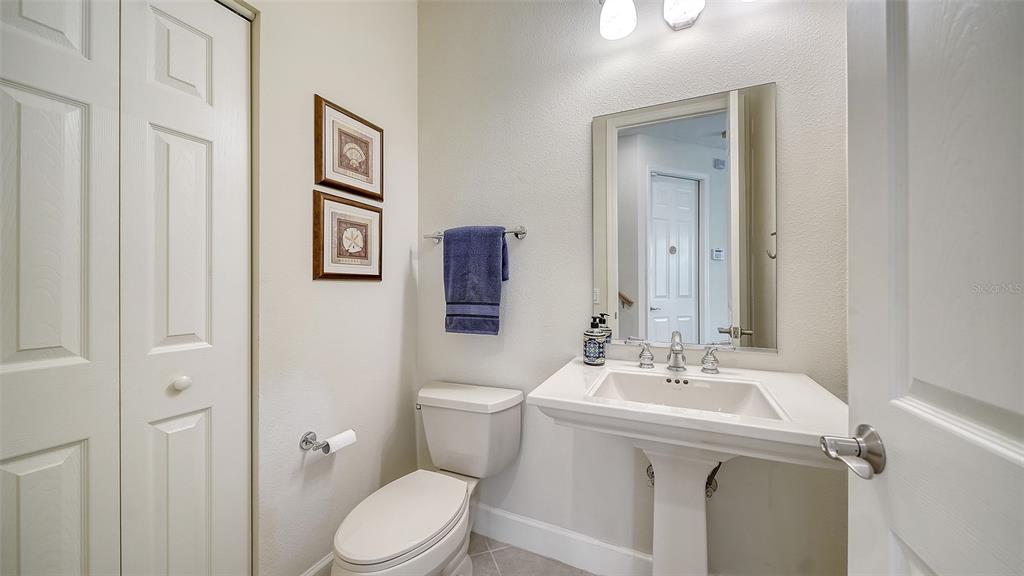 1116 Beachcomber Court, Unit 3 Osprey, FL 34229 - Photo 31 of 65 a bathroom with a sink mirror vanity and toilet