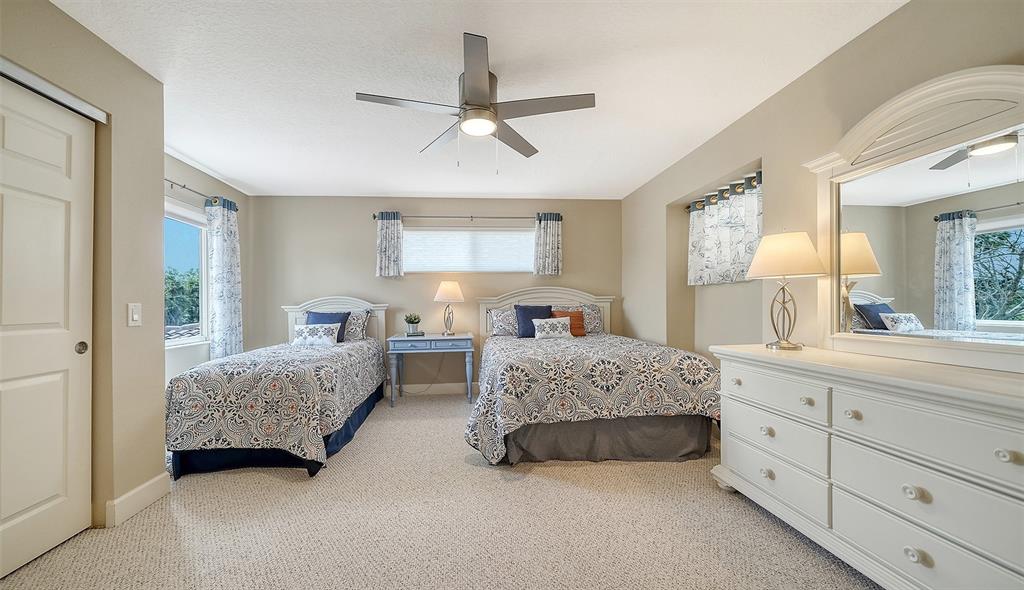 1116 Beachcomber Court, Unit 3 Osprey, FL 34229 - Photo 32 of 65 a spacious bedroom with a bed and a dresser
