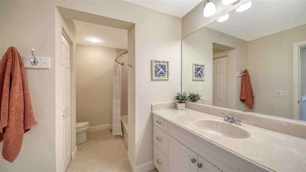 1116 Beachcomber Court, Unit 3 Osprey, FL 34229 - Photo 34 of 65 a bathroom with a sink and a mirror