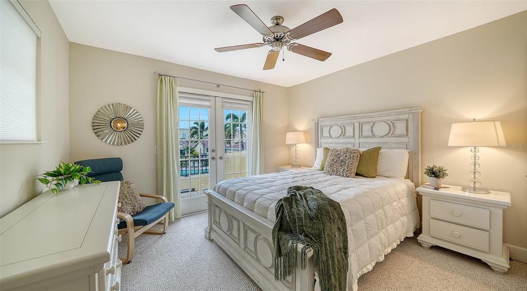 1116 Beachcomber Court, Unit 3 Osprey, FL 34229 - Photo 35 of 65 a bedroom with a bed and a table