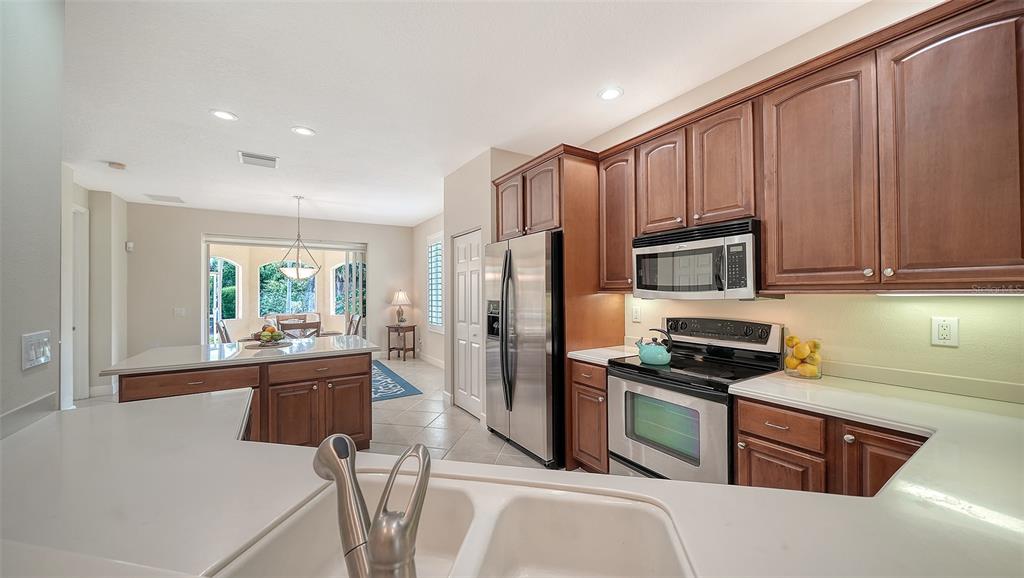 1116 Beachcomber Court, Unit 3 Osprey, FL 34229 - Photo 10 of 65 a kitchen with stainless steel appliances granite countertop a refrigerator stove and sink
