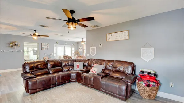 a kitchen with stainless steel appliances a sink a stove a refrigerator and cabinets