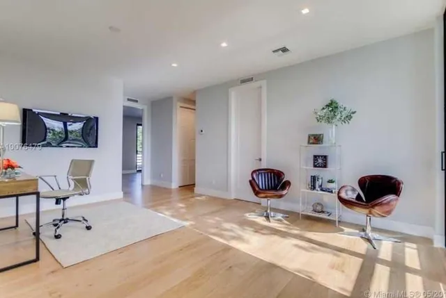 a living room with furniture and floor to ceiling window
