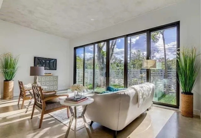 a living room with furniture and a potted plant