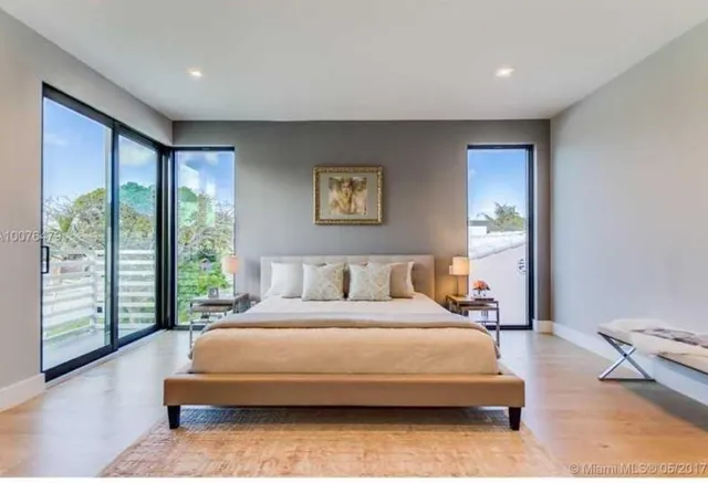 a bedroom with a large bed and a large window