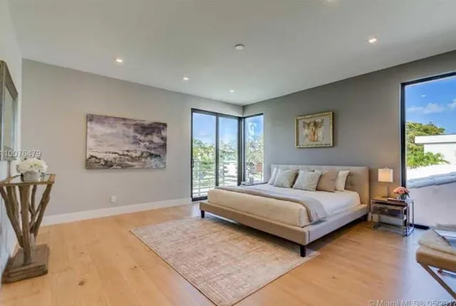 a spacious bedroom with a large bed and a window