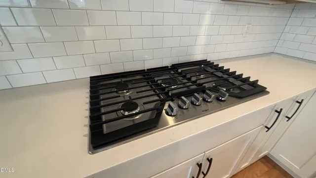 a close up of a stove top oven sitting inside of a kitchen