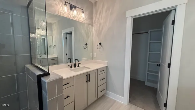 a bathroom with a sink a vanity and a mirror