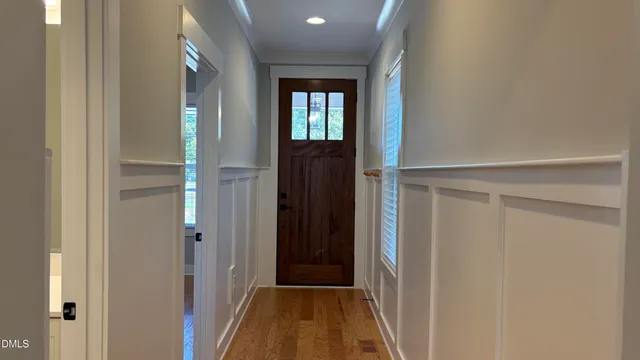 a view of a hallway with wooden floor