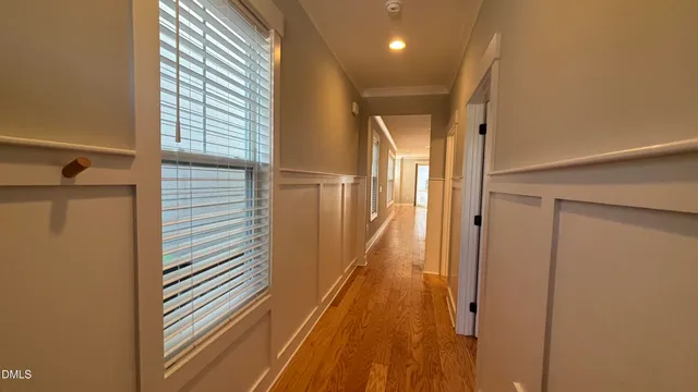 a view of a hallway with wooden floor