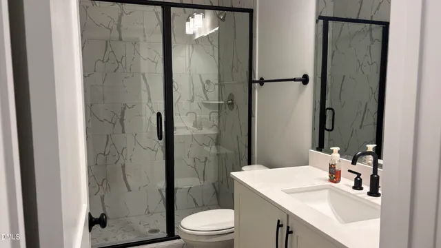 a bathroom with a sink toilet and shower