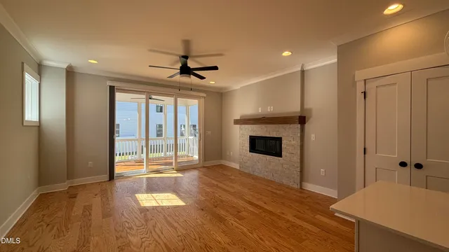 a view of a livingroom with a fireplace wooden floor and window