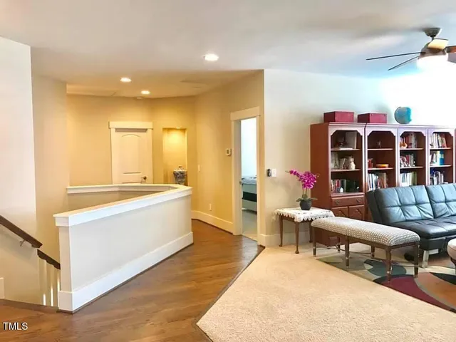 a living room with furniture and flowers