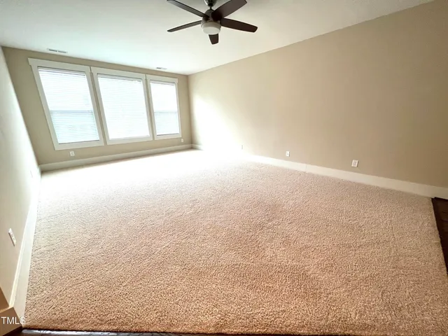 an empty room with a empty space and windows