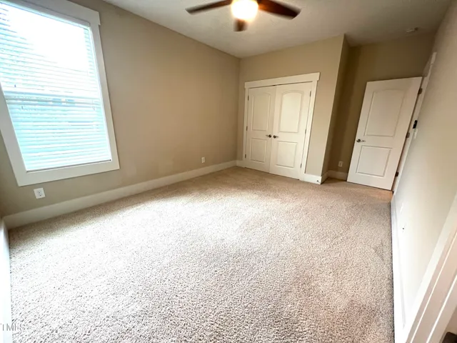 an empty room with windows and entrance