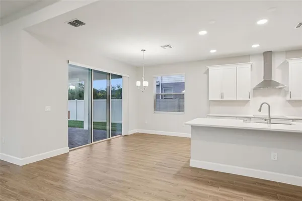 a view of wooden floor and windows in a room