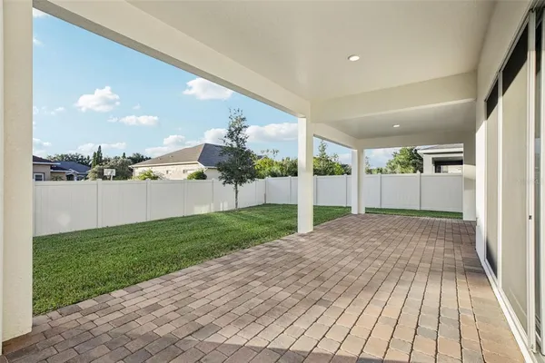 a view of a white house with a swimming pool and front door
