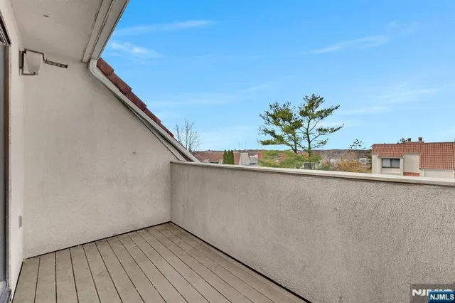 a view of balcony with wooden floor and fence