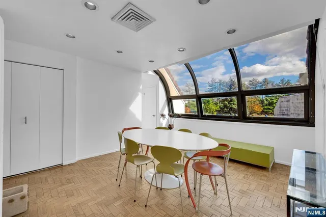 a dining room with furniture and window