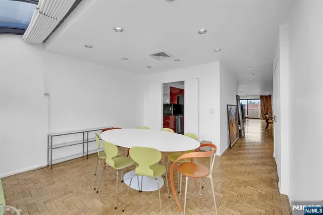 a dining room with furniture and wooden floor