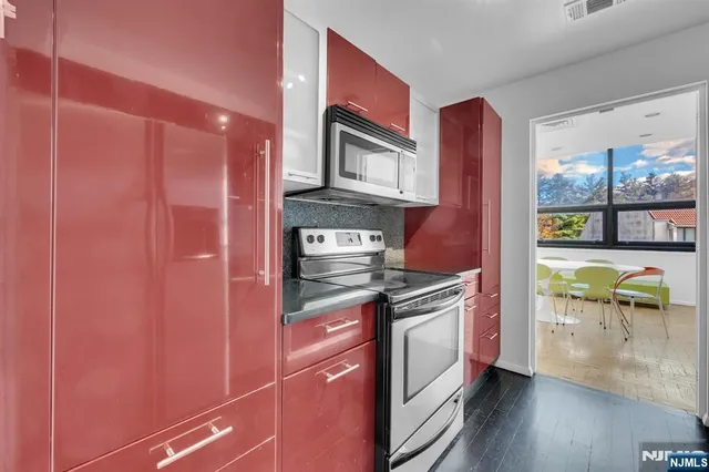 a kitchen with stainless steel appliances granite countertop a stove and a refrigerator