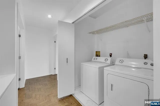 a view of storage and utility room with washer and dryer