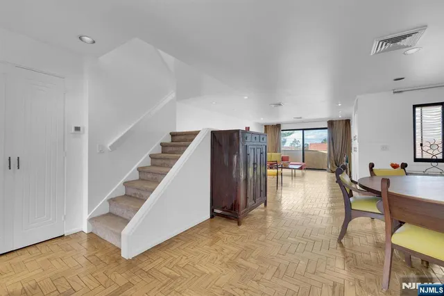 a view of a livingroom with furniture and stairs