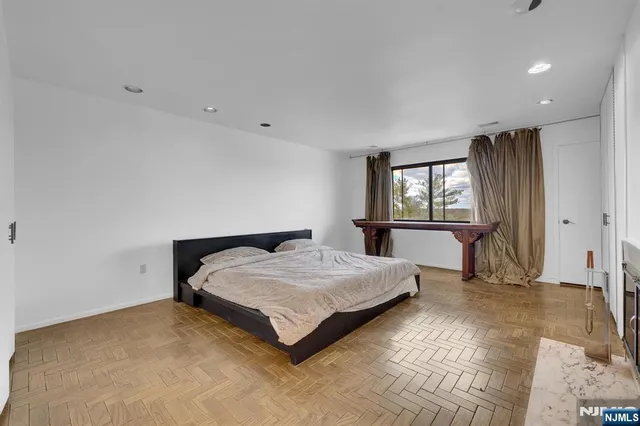 a spacious bedroom with a bed and a window