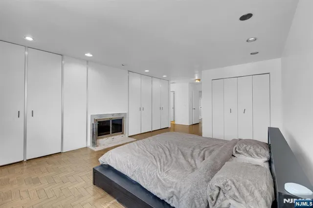 a spacious bedroom with a bed and a fireplace