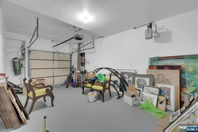 a front view of a building with lot of cars and trees