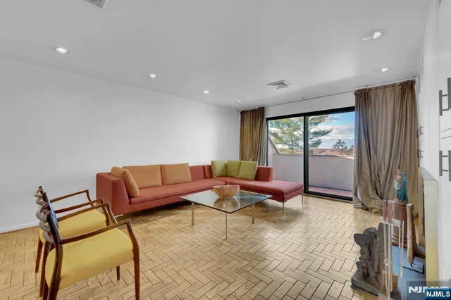 a living room with furniture and a floor to ceiling window