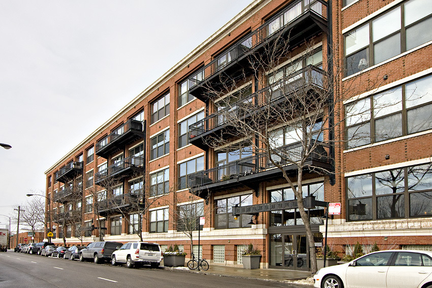 1040 West Adams Street, Unit 257 Chicago, IL 60607 - Photo 1 of 15 a couple of cars parked in front of brick building