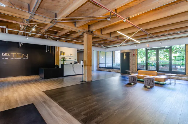 a kitchen with furniture and wooden floor