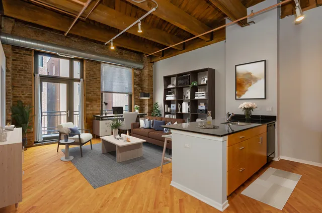 a living room with stainless steel appliances granite countertop lots of counter top space