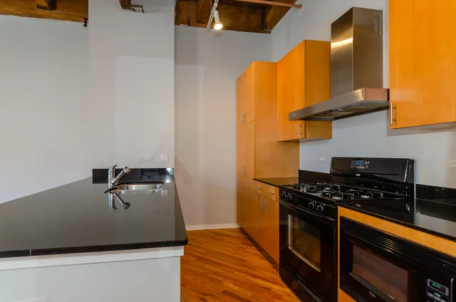 a kitchen with stainless steel appliances a stove a sink and a refrigerator