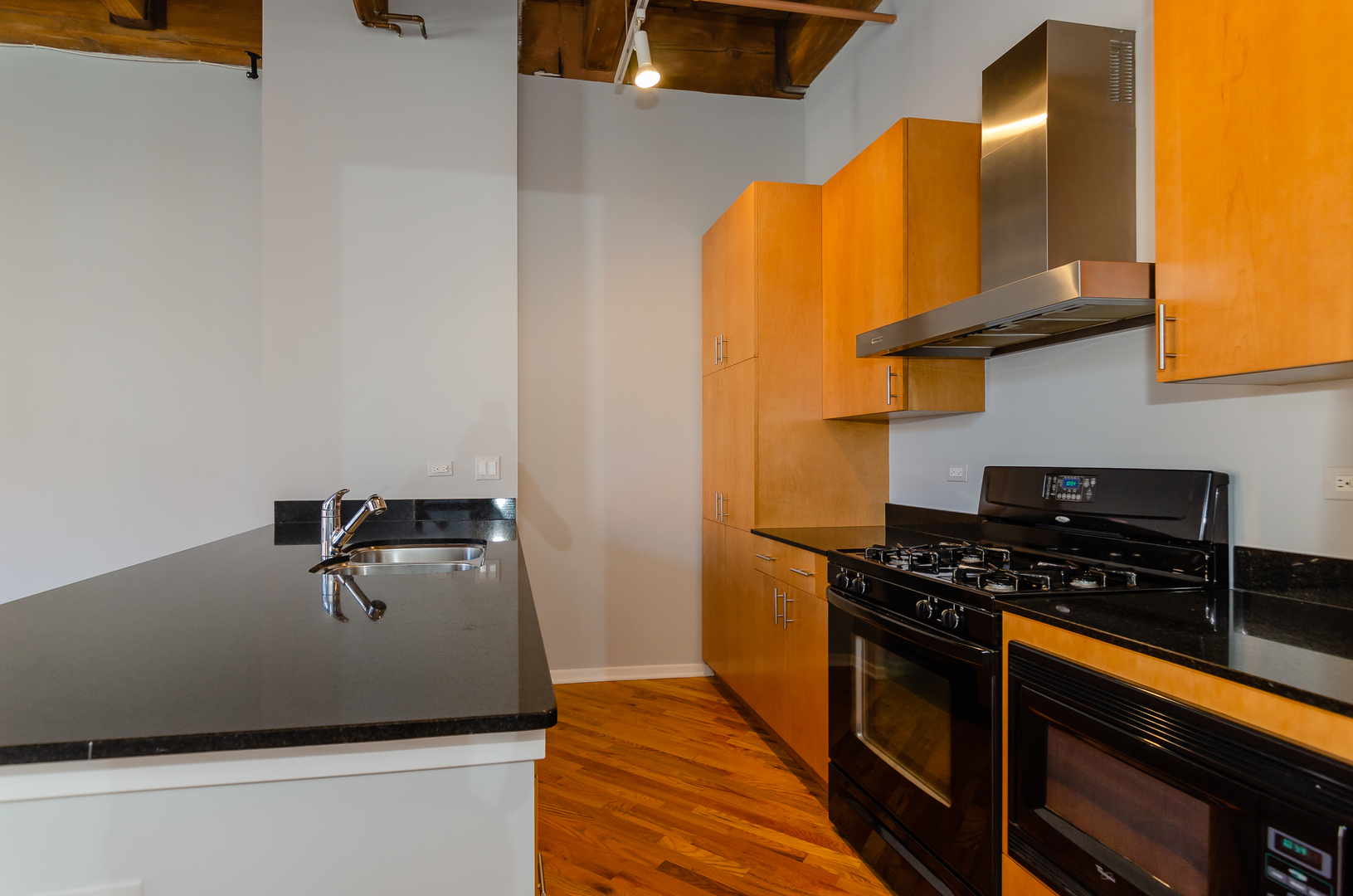 1040 West Adams Street, Unit 257 Chicago, IL 60607 - Photo 4 of 15 a kitchen with stainless steel appliances a stove a sink and a refrigerator