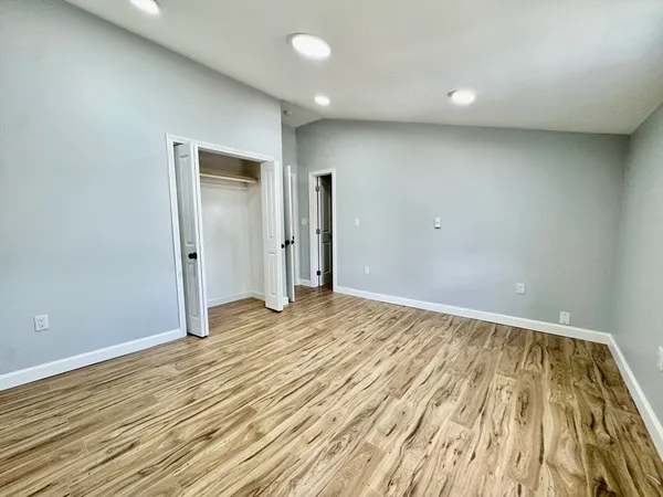a view of an empty room and wooden floor