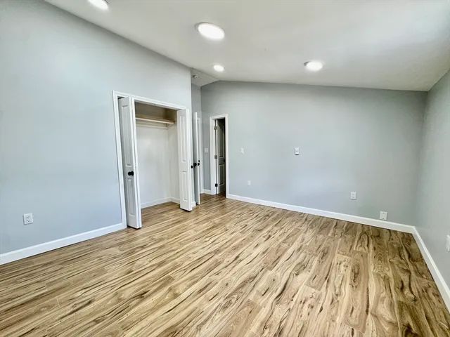a view of an empty room and wooden floor