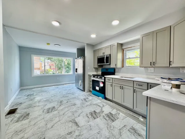 a kitchen with a stove a sink and a microwave