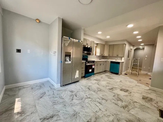 a view of kitchen and refrigerator
