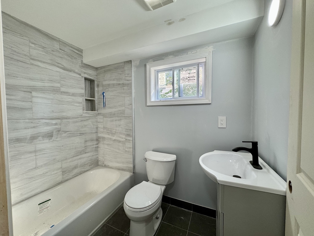 201 Belmont Street, Unit 2 Everett, MA 02149 - Photo 10 of 19 a bathroom with a sink toilet and shower