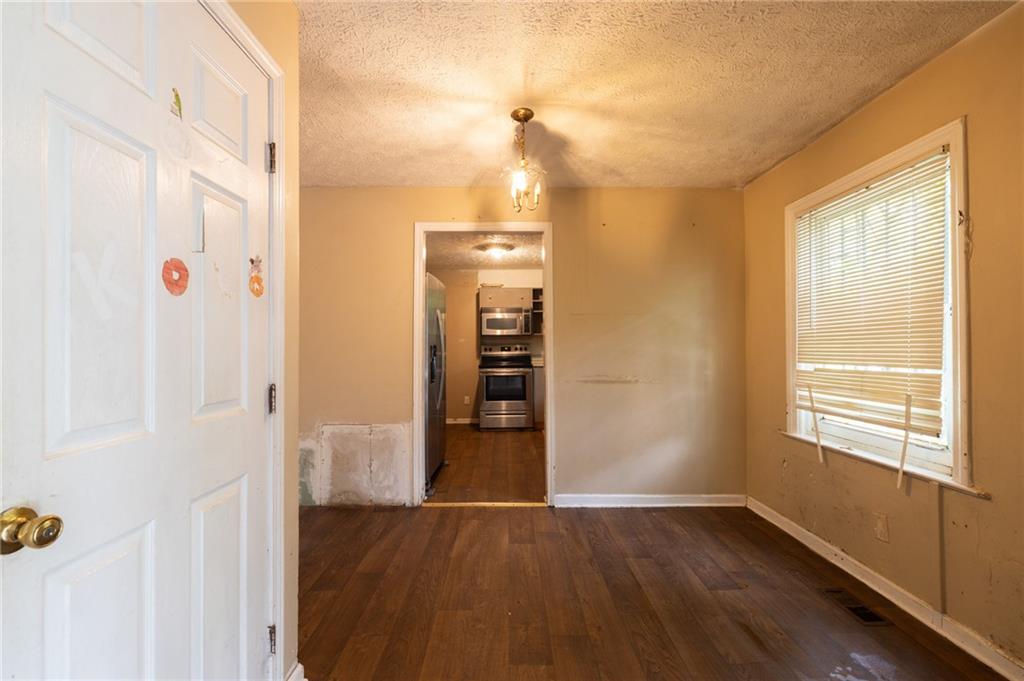 3838 Old Gordon Road Northwest Atlanta, GA 30336 - Photo 6 of 23 a view of a hallway with wooden floor and entryway